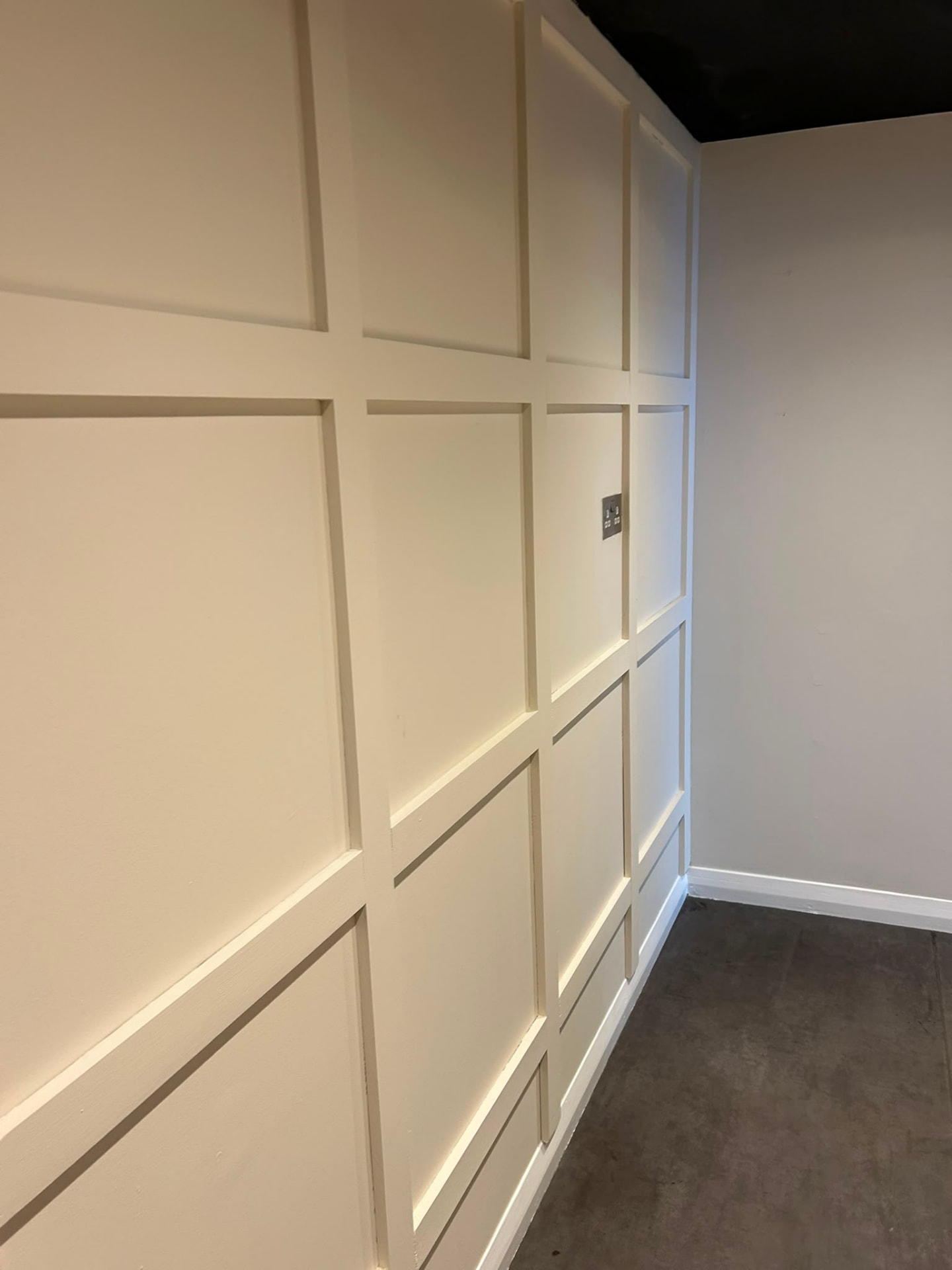 Completed commercial salon refresh in Bedford with cream panelled walls and a black ceiling.