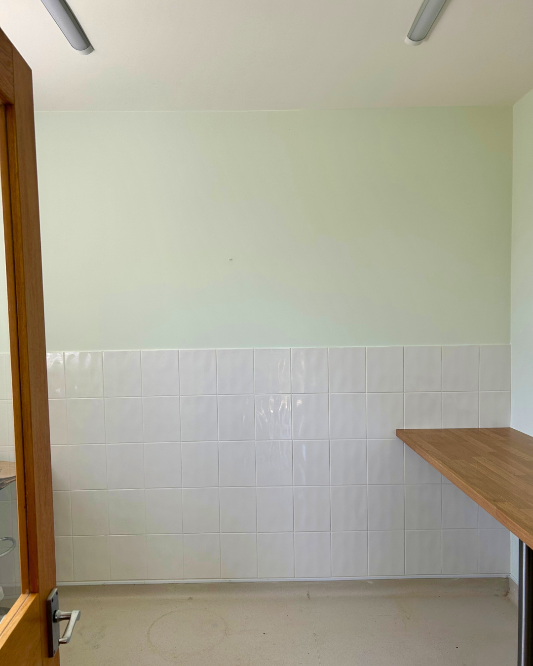 Laundry room refresh in Bedfordshire with freshly painted walls and tiled splashback.