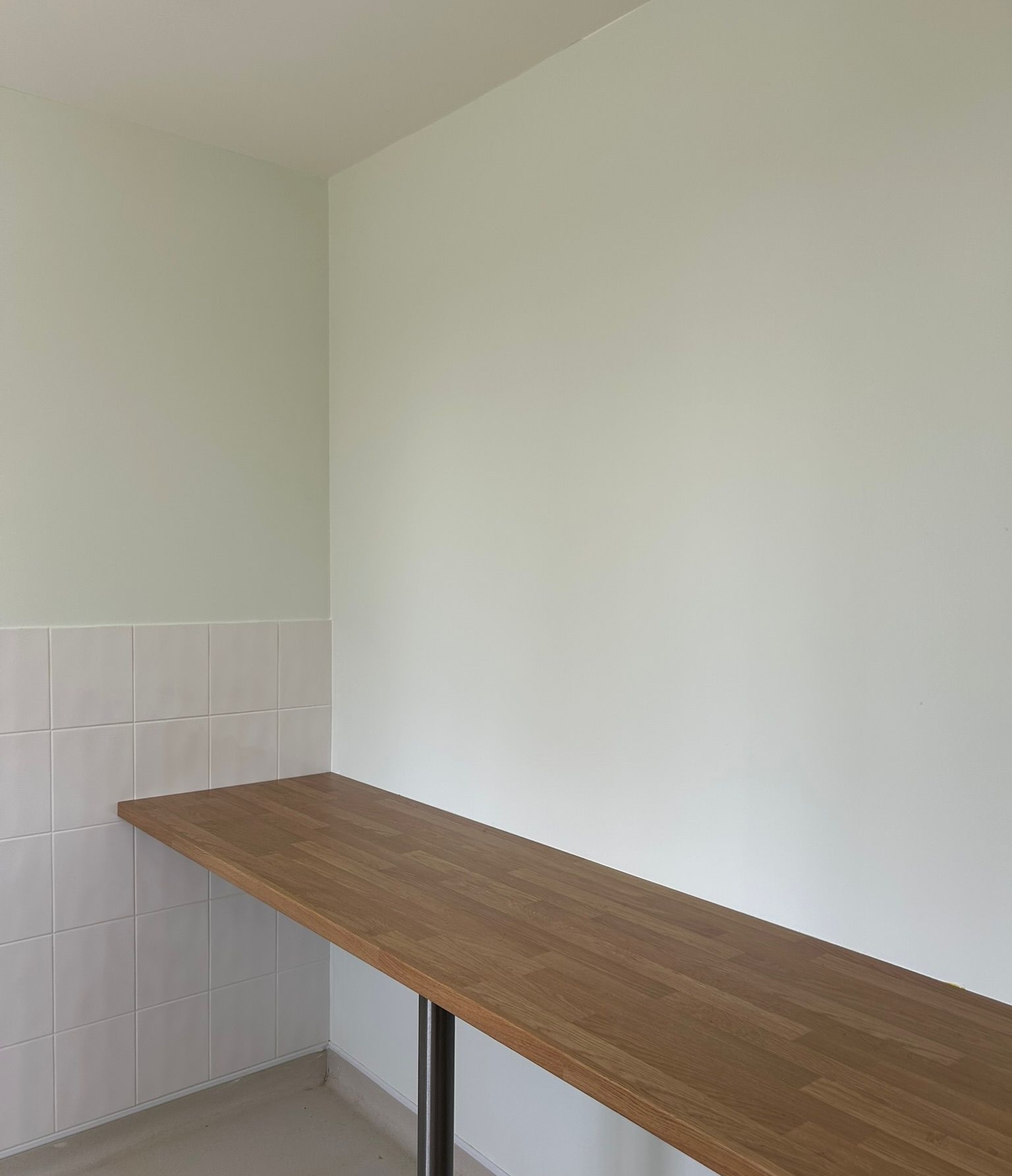 Laundry room refresh in Bedfordshire with wooden worktop and tiled splashback.
