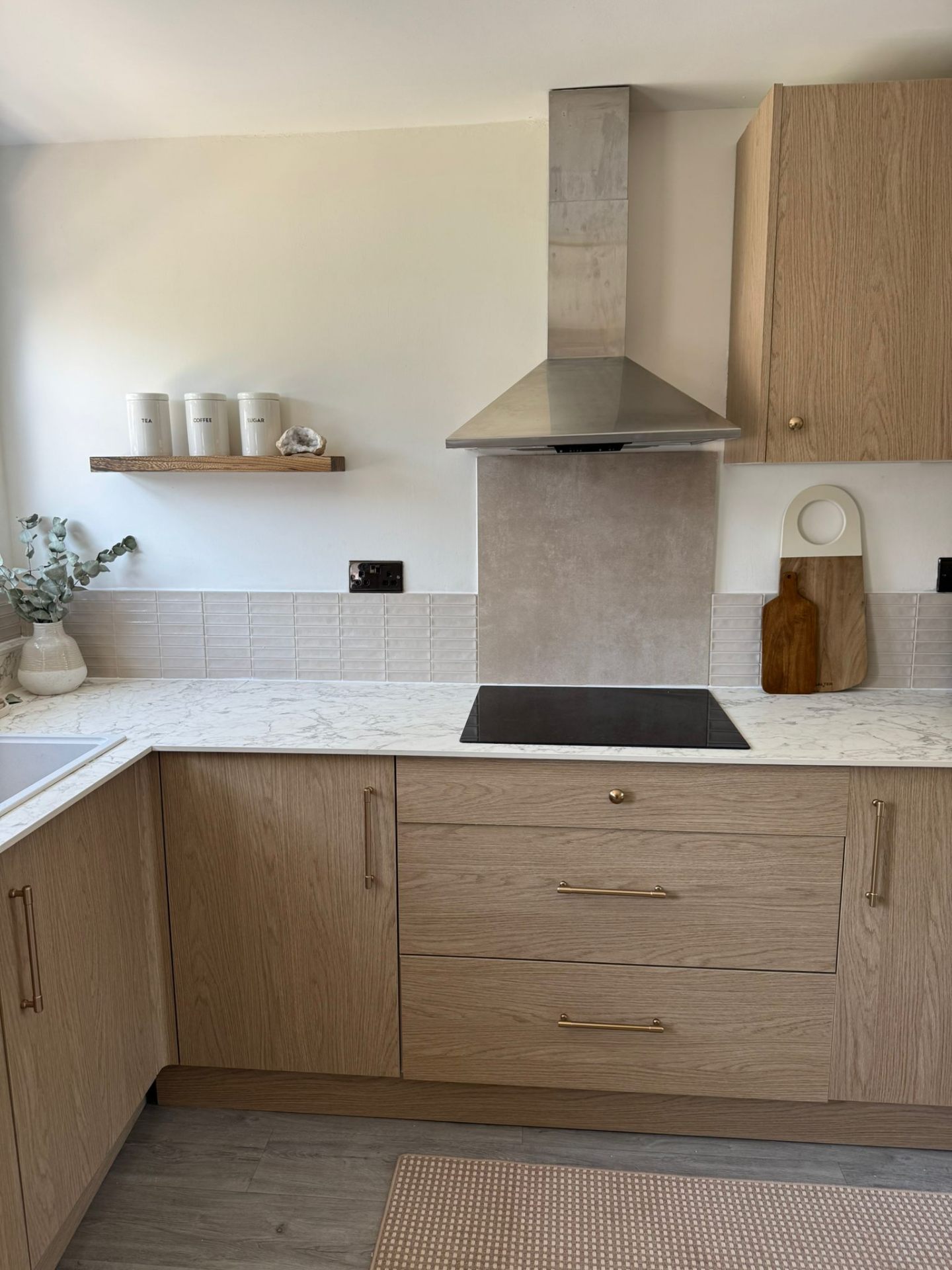 Refreshed kitchen in Bedford with new tiled splashback, freshly painted walls and oak cabinetry.