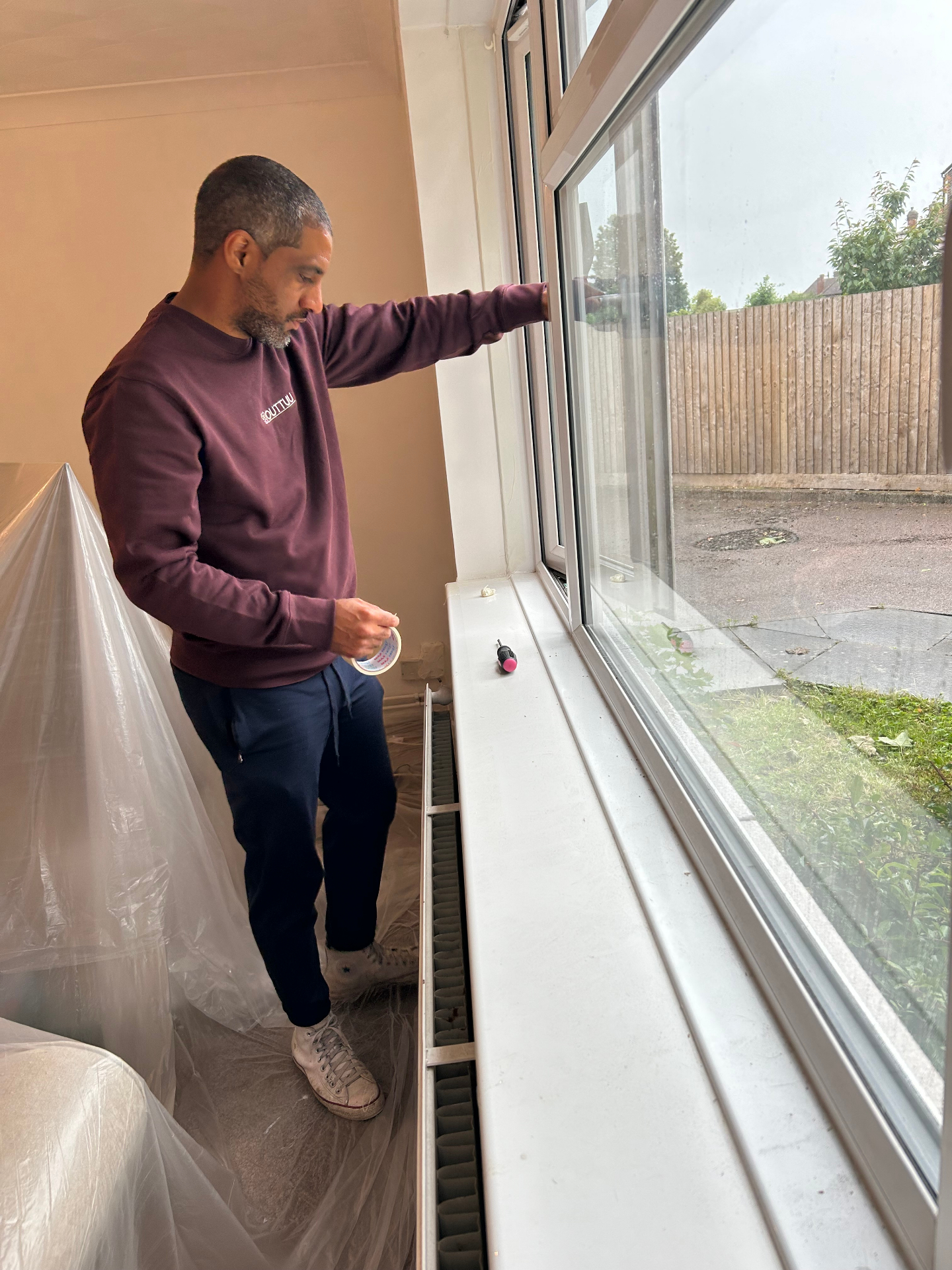 Ricky preparing a room for decorating in a Clapham home near Bedford.