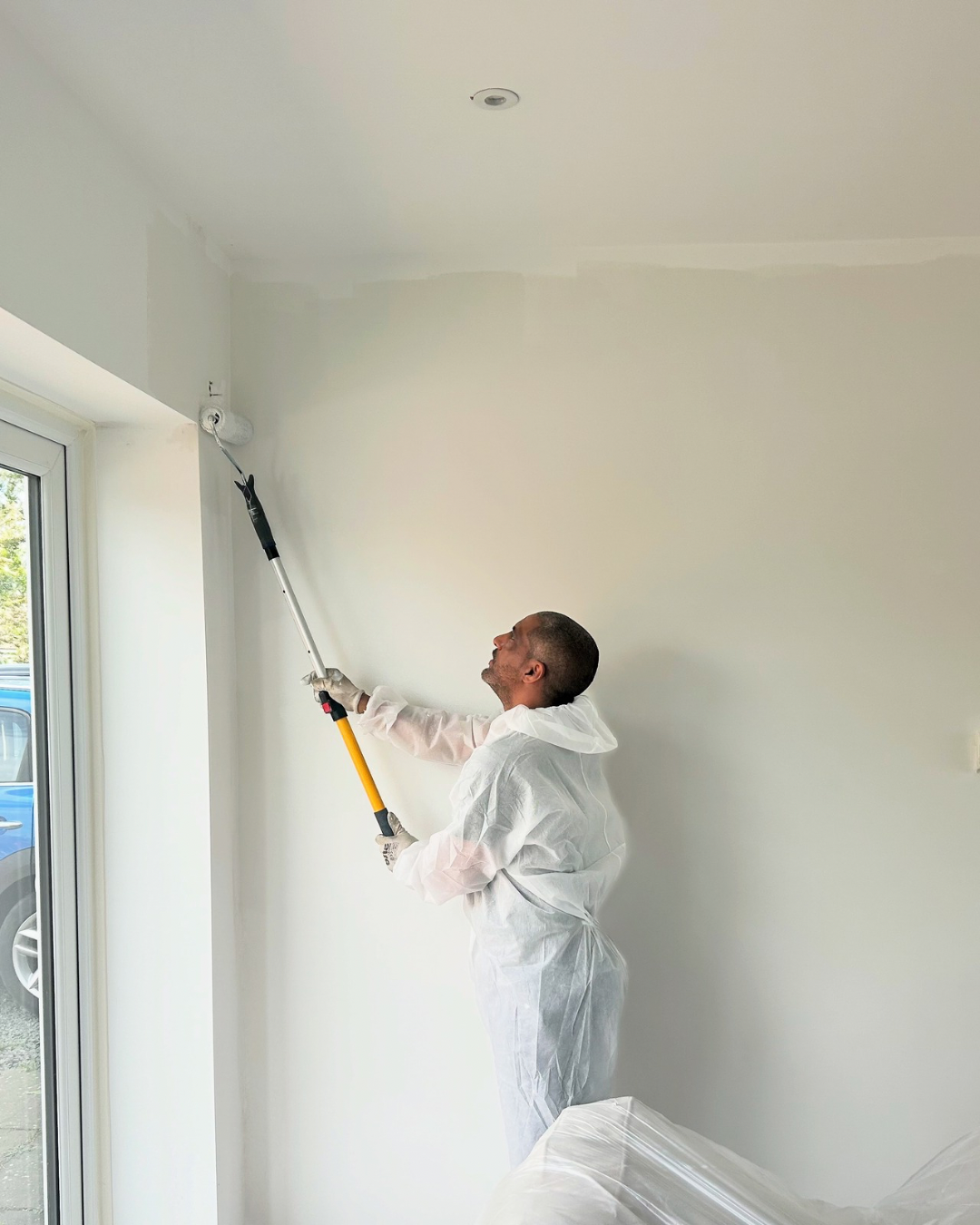 Ricky decorating a living room in Bedford while working on site for OUTTUU.