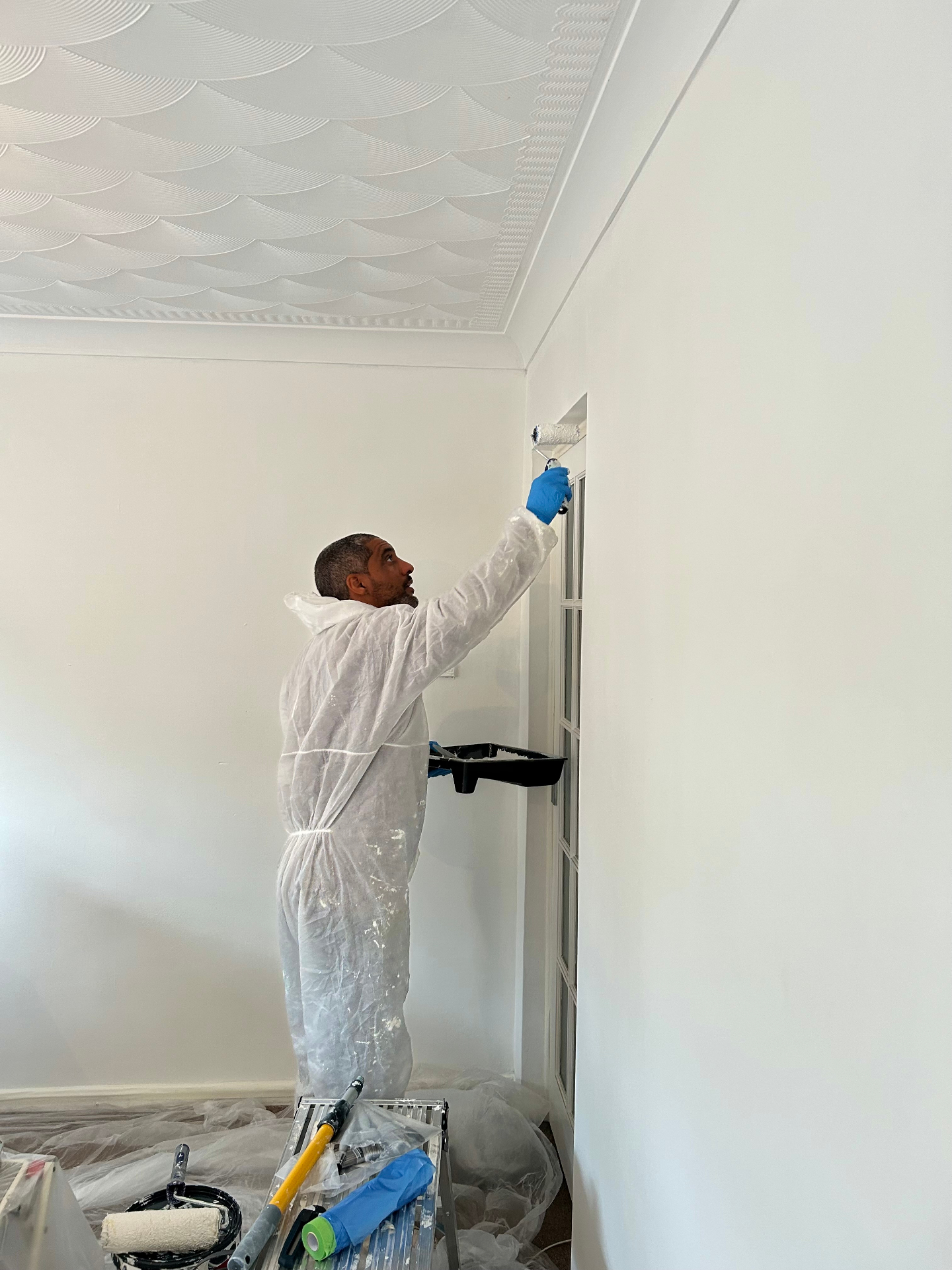 Ricky painting a living room refresh project in Bedford.